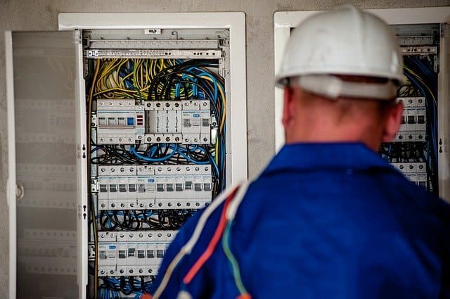 Electrician standing near utility panel